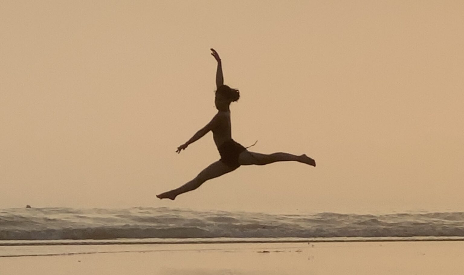Sunrise leap on Cam An beach, Vietnam